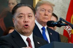 In this Thursday, Nov. 2, 2017, file photo, Broadcom CEO Hock Tan speaks while U.S. President Donald Trump listens, in background, during an event at the White House in Washington, to announce the company is moving its global headquarters to the United States. In a decision announced Monday, March 12, 2018, Trump is blocking Singapore chipmaker Broadcom from pursuing a hostile takeover of U.S. rival Qualcomm on the grounds that the combination would threaten national security.