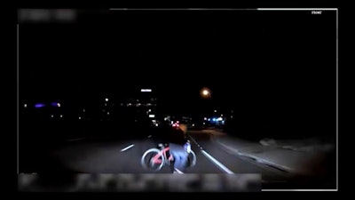 This image made from video Sunday, March 18, 2018, of a mounted camera provided by the Tempe Police Department shows an exterior view moments before an Uber SUV hit a woman in Tempe, Ariz. Video of a deadly self-driving vehicle crash in suburban Phoenix shows the pedestrian walking from a darkened area onto a street just moments before the crash.