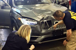 In this March 20, 2018, photo provided by the National Transportation Safety Board, investigators examine a driverless Uber SUV that fatally struck a woman in Tempe, Ariz. The fatality prompted Uber to suspend all road-testing of such autos in the Phoenix area, Pittsburgh, San Francisco and Toronto.