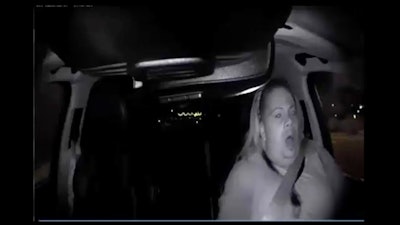 This image made from video Sunday, March 18, 2018, of a mounted camera provided by the Tempe Police Department shows an interior view moments before an Uber SUV hit a woman in Tempe, Ariz. The video shows a human backup driver in the SUV looking down until seconds before the crash. The driver looked up and appeared startled during the last moment of the clip.