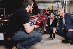 This is a photo of new valve technology that promises cheaper, greener engines, Amir Khajepour, a professor of mechanical and mechatronics engineering at Waterloo, in his lab working with his students.