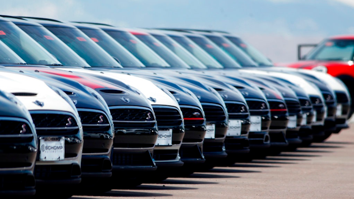 In this Friday, March 30, 2018, photograph, a line of unsold 2018 Cooper Clubmen sit in a long row at a Mini dealership in Highlands Ranch, Colo. U.S. auto sales grew 6.3 percent in March on rising sales of SUVs and pickup trucks.