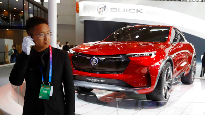 A security person stands near a Buick concept SUV during the start of the Auto China 2018 in Beijing, China, Wednesday, April 25, 2018. Volkswagen and Nissan have unveiled electric cars designed for China at the Beijing auto show that highlights the growing importance of Chinese buyers for a technology seen as a key part of the global industry's future.