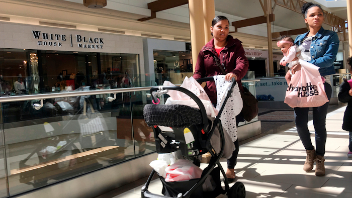 Shoppers walk in a mall in Salem, N.H.