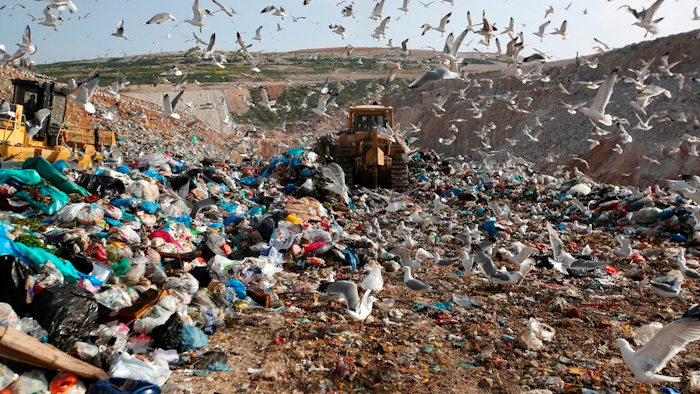 In this Wednesday, Feb. 2, 2018 file photo, earthmovers push mountains of garbage as seagulls fly over the country's largest landfill at Fyli on the outskirts of Athens. The British government is planning a consultation about a possible bill to end the use of plastic straws, drink stirrers and cotton buds - and is urging other Commonwealth nations to ban the practice as well. Prime Minister Theresa May said Thursday, April 19, 2018 that “plastic waste is one of the greatest environmental challenges facing the world.”