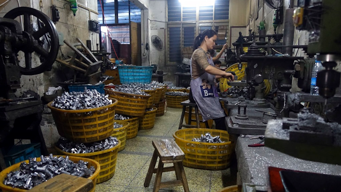 In this Wednesday, Oct. 21, 2015 file photo, a worker manufactures metal parts in an auto parts factory in Rui'an near Wenzhou city in eastern China's Zhejiang province. Chinese exporters of goods from electronics to motorcycle parts are scrambling to insulate themselves from U.S. President Donald Trump’s proposed tariff hike. They are weighing plans to rush shipments to American customers ahead of the increase, raise prices or find other markets. Some are looking at shipping goods through other countries to hide their Chinese origin.