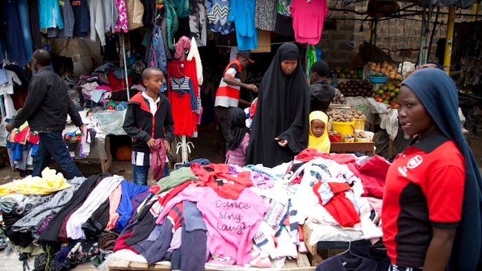In this Sunday April 8, 2018 people look through piles of second hand clothes at a roadside stall, in Nairobi, Kenya. The used clothes cast off by Americans and sold in bulk in African nations, a multimillion-dollar business, have been blamed in part for undermining local textile industries.