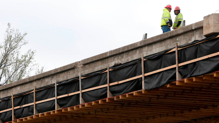 In this file photo, construction workers prepare for the teardown of a U.S. 75 bridge deck over Southwest Boulevard in Tulsa.