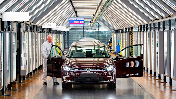 In this March 5, 2018 file photo Roland Schulz makes the final check of an e-Golf electric car in the so-called light tunnel in the German car manufacturer Volkswagen's Transparent Factory in Dresden, Germany . The supervisory board of the German car maker is convening Thursday, April 12, 2018 to discuss a new leadership structure.