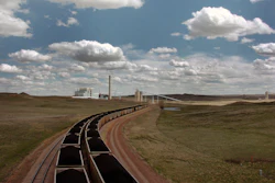 In this April 29, 2010 file photo, a pair of coal trains idle on the tracks near Dry Fork Station, a coal-fired power plant being built by the Basin Electric Power Cooperative near Gillette, Wyo. Ten teams competing to make money from carbon dioxide pollution will share $5 million in prize money and advance to the final round of an international competition. Five of the finalists will compete to make use of actual flue gases from this Wyoming plant. The other five will compete at a gas-fired power plant in Alberta, Canada.