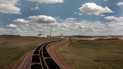 In this April 29, 2010 file photo, a pair of coal trains idle on the tracks near Dry Fork Station, a coal-fired power plant being built by the Basin Electric Power Cooperative near Gillette, Wyo. Ten teams competing to make money from carbon dioxide pollution will share $5 million in prize money and advance to the final round of an international competition. Five of the finalists will compete to make use of actual flue gases from this Wyoming plant. The other five will compete at a gas-fired power plant in Alberta, Canada.
