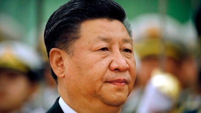 In this March 29, 2018, file photo, Chinese President Xi Jinping reviews an honor guard during a welcome ceremony at the Great Hall of the People in Beijing. Xi has promised to cut China's auto import tariffs and ease restrictions on foreign ownership in its auto industry amid an escalating tariff spat with Washington, in a speech Tuesday, April 10, 2018 at a business conference.