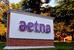 In this June 1, 2017, file photo, a sign stands on the campus of the Aetna headquarters in Hartford, Conn. Some major health insurers plan to take a little sting out of prescription drug prices by giving customers rebates at the pharmacy counter, and they could spark a trend. Aetna and UnitedHealthcare both say they will begin passing rebates they get from drugmakers along to some of their customers starting next year.