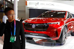 A security person stands near a Buick concept SUV during the start of the Auto China 2018 in Beijing, China, Wednesday, April 25, 2018. Volkswagen and Nissan have unveiled electric cars designed for China at the Beijing auto show that highlights the growing importance of Chinese buyers for a technology seen as a key part of the global industry's future.