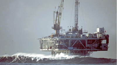 In this file photo, waves break by an oil platform that's offshore from Seal Beach, California.