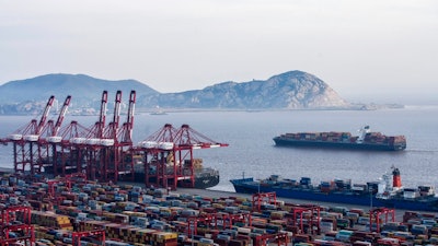 In this March. 29, 2018 photo, container ships is docked at the Yangshan port in Shanghai. President Donald Trump has instructed the U.S. trade representative to consider slapping an additional $100 billion in tariffs on Chinese goods in a dramatic escalation of the trade dispute between the two countries. The news comes a day after Beijing announced plans to tax $50 billion in U.S. products, including soybeans and small aircraft, in response to a U.S. move earlier this week to slap tariffs on $50 billion in Chinese imports.