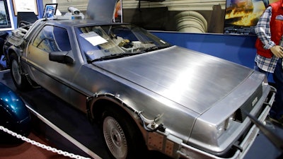 This Tuesday, Dec. 24, 2013, file photo shows a 1981 DeLorean DMC-12 sports car decorated to resemble the vehicles used to portray a time machine in the 'Back to the Future' movie franchise, shown in a display about the movies at the Miami Auto Museum at the Dezer Collection in North Miami, Fla. Sally DeLorean, the widow of maverick automaker John DeLorean, filed a federal lawsuit in New Jersey on Monday, April 23, 2018, alleging the DeLorean Motor Company in Humble, Texas – not affiliated with the automaker founded by John DeLorean that went bankrupt in 1982 – isn't entitled to money that the lawsuit says the Texas company received from Universal Pictures, the studio that distributed and helped produce the movies.