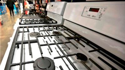 In this April 11, 2018, photo, a customer looks over a selection of stoves that are available for sale at a big box store in Cranberry Township, Pa. On Thursday, April 26, the Commerce Department releases its March report on durable goods.