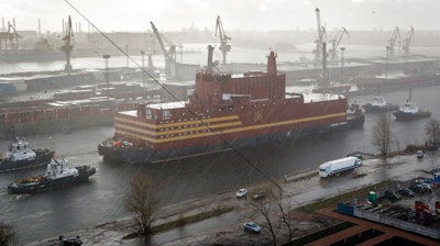 The floating nuclear power plant, the 'Akademik Lomonosov', is towed out of the St. Petersburg shipyard where it was constructed in St.Petersburg, Russia, Saturday, April 28, 2018. The Akademik Lomonosov is to be loaded with nuclear fuel in Murmansk, then towed to position in the Far East in 2019.