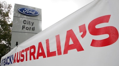 In this May 23, 2013 file photo, a banner is displayed at a Ford dealership in Sydney. Ford Motor Co.’s Australian subsidiary was fined 10 million Australian dollars ($7.6 million) by an Australian court on Thursday, April 26, 2018, for mishandling customer complaints about faulty automatic transmissions in thousands of cars.