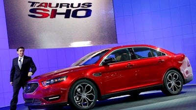 This April 20, 2011, file photo shows Mark Fields, executive vice president, Ford Motor Company, introducing the 2013 Ford Taurus SHO at the New York International Auto Show. In about a year, a car that once was the most popular in America will die for a second time. Ford Taurus, rest peacefully in heaven’s salvage yard. Blame the full-size sedan’s slow death on the national obsession with SUVs and Ford Motor Co.’s need to slash costs and remake itself for a new era of self-driving cars and shuttles. Ford announced the car’s demise on Wednesday, April 25, 2018, as part of major restructuring plan to focus capital spending on more popular SUVs and technology needed to morph into a mobility company.