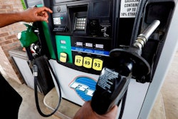 In this April 23, 2018, file photo a customer prepares to make his selection among the various offerings at the gasoline pump in Richland, Miss. Crude oil prices are at the highest level in more than three years and expected to climb higher, pushing up gasoline prices along the way.