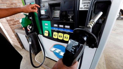 In this April 23, 2018, file photo a customer prepares to make his selection among the various offerings at the gasoline pump in Richland, Miss. Crude oil prices are at the highest level in more than three years and expected to climb higher, pushing up gasoline prices along the way.