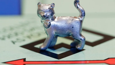 In this Tuesday, Feb. 5, 2013 file photo, the newest Monopoly token, a cat, rests on the game board at Hasbro Inc. headquarters, in Pawtucket, R.I. Hasbro Inc. (HAS) on Monday, April 23, 2018, reported a first-quarter loss of $112.5 million, after reporting a profit in the same period a year earlier.