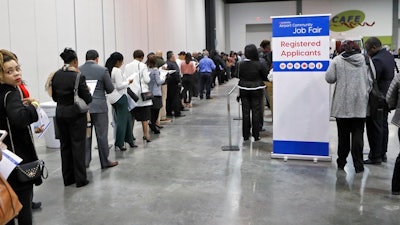 In this March 27, 2018, photo, applicants line up for the opening of the job fair, held by Hartsfield Jackson Airport in Atlanta. The job fair featured more than 60 of the Airport community's top employers. On Wednesday, April 4, 2018, payroll processor ADP reports how many jobs private employers added in March.