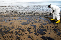 In this May 21, 2015, file photo, a worker removes oil from sand at Refugio State Beach, north of Goleta, Calif. Jurors being selected Thursday, April 19, 2018, in Santa Barbara County Superior Court will determine if Plains All American Pipeline, a Texas company that operated an oil pipeline that spilled crude along the California three years ago, broke any laws.
