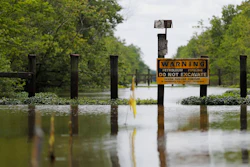 In this Friday, April 27, 2018 photo, a sign and barrier for an existing pipeline is displayed on Bayou Sorrel in the Atchafalaya River Basin in Louisiana. A company building a crude oil pipeline is asking a federal appeals court to throw out a judge's order that had suspended construction work in the environmentally fragile swamp. A three-judge panel of the 5th U.S. Circuit Court of Appeals is scheduled to hear arguments Monday, April 30, by attorneys for Bayou Bridge Pipeline LLC, federal regulators and environmental groups opposed to the project. In February, a judge temporarily stopped all pipeline construction work in the Atchafalaya Basin.