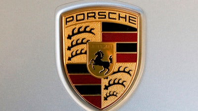 The Feb. 15, 2018 file photo shows a Porsche logo on a 2018 718 Cayman automobile on display at the Pittsburgh Auto Show. German police searched offices of Porsche on Wednesday, April 18, 2018.