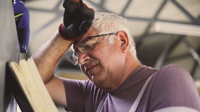 Senior Man In Workshop Worried Man Reading His Planner 860954184 2125x1417