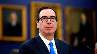 In this April 11, 2018, file photo, Treasury Secretary Steve Mnuchin smiles as he testifies on the FY2019 budget during a hearing of the House Appropriations Committee Subcommittee on State, Foreign Operations, and Related Programs, on Capitol Hill in Washington. Mnuchin plans to lead a delegation of American officials to Beijing next week.