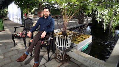 In this March 23, 2018, photo, Shane Pliska, owner of Planterra, a commercial florist and owner of a wedding venue where the decor is all about flowers and plants poses for a photo at his company, in West Bloomfield, Mich. When Hurricane Irma forced Miami International Airport to shut down in September, flower shipments from South America, couldn’t arrive. But the floral industry is set up for such contingencies, and distributors quickly arranged for shipments from other parts of the world. Pliska got flowers from Kenya in that case.