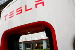 A sales person stands inside a Tesla electric vehicle showroom in Beijing, Thursday, April 5, 2018. The United States and China, the world's two largest economies, have roiled financial markets and fueled fears of a protracted trade war by threatening tariffs this week on each other's goods. The United States on Tuesday said it would impose 25 percent duties on $50 billion of imports from China, and China quickly retaliated by listing $50 billion of products that it could hit with its own 25 percent tariffs.