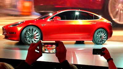 In this March 31, 2016, file photo, Tesla Motors unveils the new lower-priced Model 3 sedan at the Tesla Motors design studio in Hawthorne, Calif. Electric car maker Tesla Inc. increased production of its Model 3 mass-market car in the first quarter but still fell far short of the numbers it promised last summer.