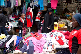 In this Sunday April 8, 2018 people look through piles of second hand clothes at a roadside stall, in Nairobi, Kenya. The used clothes cast off by Americans and sold in bulk in African nations, a multimillion-dollar business, have been blamed in part for undermining local textile industries.