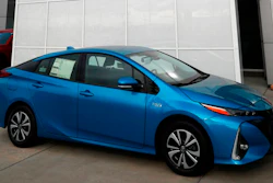An unsold 2018 Prius sits on a Toyota dealer's lot in the south Denver suburb of Englewood, Colo. Toyota says it will start equipping models with technology to talk to other vehicles starting in 2021, as it tries to push safety communications forward.