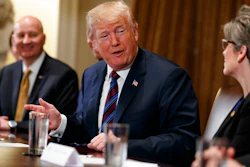 Gov. Pete Ricketts, R-Neb., left, listens as President Donald Trump speaks to Sen. Joni Ernst, R-Iowa, during a meeting with governors and lawmakers in the Cabinet Room of the White House, Thursday, April 12, 2018, in Washington.