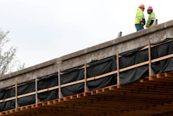 In this file photo, construction workers prepare for the teardown of a U.S. 75 bridge deck over Southwest Boulevard in Tulsa.