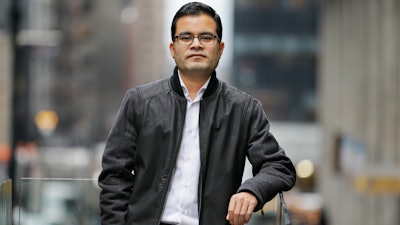 In this Tuesday, Feb. 20, 2018 photo, Akash Negi poses for a picture near his office in New York. Donald Trump says he wants more 'merit-based' immigrants as opposed to those who arrive due to family ties, but his administration has taken steps to make life difficult for those skilled immigrants already in the U.S. Negi moved to the United States after his father got a diplomatic visa as part of a job at the United Nations, but his legal residency doesn’t include a work permit.