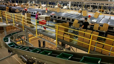 In this Dec. 13, 2005 file photo, workers fill boxes with merchandise at the Amazon fulfillment center in Fernley, Nev. Online retailer Amazon said Wednesday, April 4, 2018, it will build another warehouse packing and distribution center in the Las Vegas area. The facility should open next year on 800,000-square-feet of vacant land east of Interstate 15, not far from the Las Vegas Motor Speedway, the company and city of North Las Vegas said in statements.