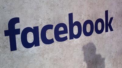 This Jan. 17, 2017, file photo shows a Facebook logo being displayed in a start-up companies gathering at Paris' Station F, in Paris. Facebook is on the offensive to try to contain swirling concerns about how it protects the data of its 2.2 billion members. As CEO Mark Zuckerberg prepares to face Congress on Tuesday, April 10, 2018, and the company rolls out new privacy rules, the social media juggernaut is facing the most serious challenge in its 14-year-history and seeking to maintain people’s trust and avoid a user exodus