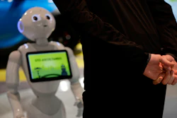In this photo dated March 12, 2018, a guests asks robot Robby Pepper for information at the front desk of hotel in Peschiera del Garda, northern Italy. Robby Pepper, billed as Italy's first robot concierge, has been programed to answer simple guest questions in Italian, English and German, the humanoid, speaking robot will be deployed all season at a hotel on the popular Garda Lake to help relieve the desk staff of simple, repetitive questions.