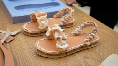 Two University of Delaware students have fashioned a biodegradable shoe using mushrooms, chicken feathers and textile waste. The prototype shoe consists of a mycelium-based sole, covered with vegan 'leather,' and an all-natural cotton fabric top.