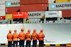 Chinese workers stand in front of a loaded cargo ship docked at a port in Qingdao in east China's Shandong province, Sunday, April 8, 2018. Amid falling markets, President Donald Trump's new economic adviser, Larry Kudlow, says there is no trade war between the U.S. and China. Another administration official, Treasury Secretary Steve Mnuchin, takes a different tack, saying he's 'cautiously optimistic' that before any threatened tariffs go into place the two nations will reach an agreement. Global financial markets have fallen sharply as the world's two biggest economies square off.