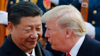 In this Nov. 9, 2017, photo, U.S. President Donald Trump, right, talks to Chinese President Xi Jinping during a welcome ceremony at the Great Hall of the People in Beijing. The brewing China-U.S. trade conflict features two leaders who’ve expressed friendship but are equally determined to pursue their nation's interests and their own political agendas. But while Trump faces continuing churn in his administration and a tough challenge in midterm congressional elections, Xi leads an outwardly stable authoritarian regime. Xi recently succeeded in pushing through a constitutional reform allowing him to rule for as long as he wishes while facing no serious electoral challenge.