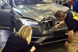 In this March 20, 2018, photo provided by the National Transportation Safety Board, investigators examine a driverless Uber SUV that fatally struck a woman in Tempe, Ariz. The fatality prompted Uber to suspend all road-testing of such autos in the Phoenix area, Pittsburgh, San Francisco and Toronto.
