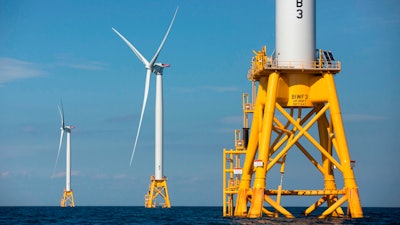 Three of Deepwater Wind's turbines stand in the water off Block Island, R.I. Using federal offshore leases, wind power projects along the East Coast are pressing ahead in 2018.